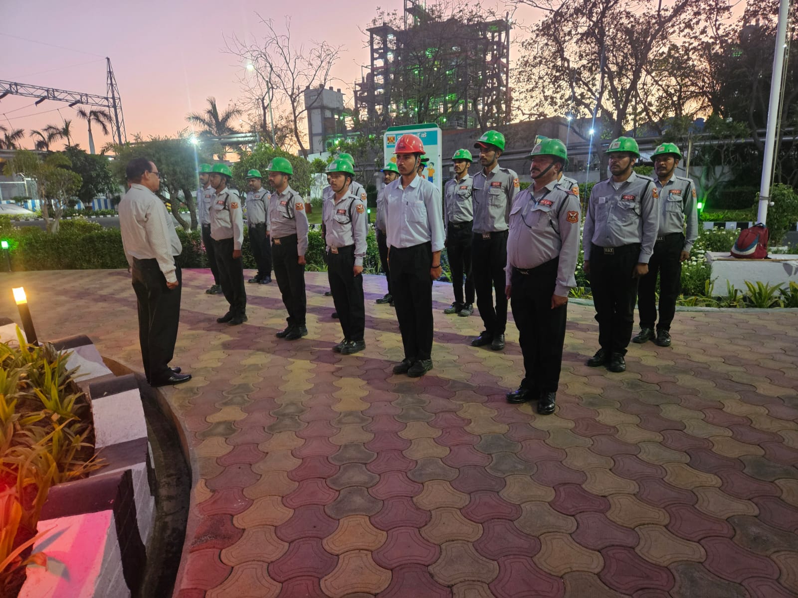 Industrial site briefing with hard-hat security team