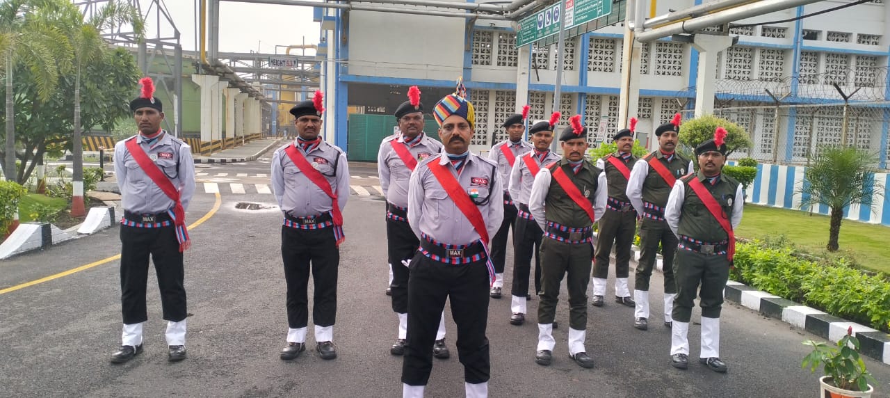 Ceremonial formation of Max Vigil guards at industrial site