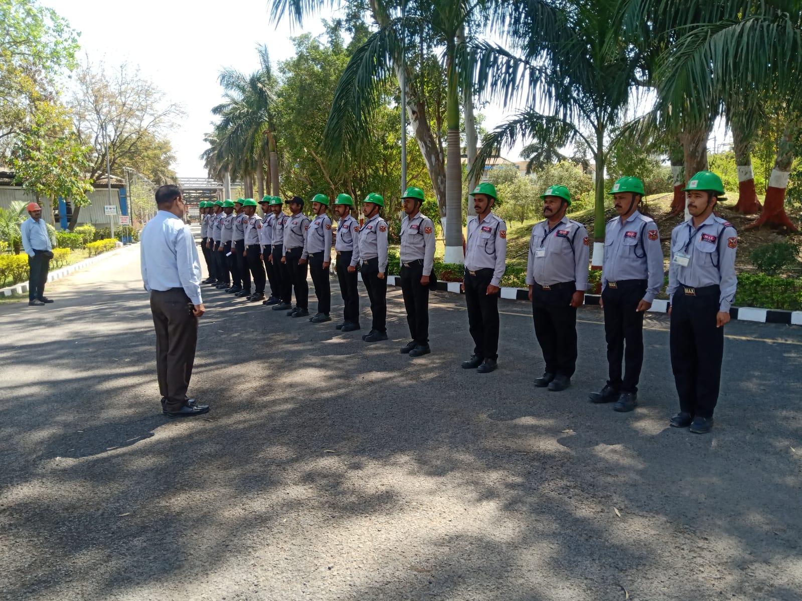 Hard-hat security briefing at industrial campus